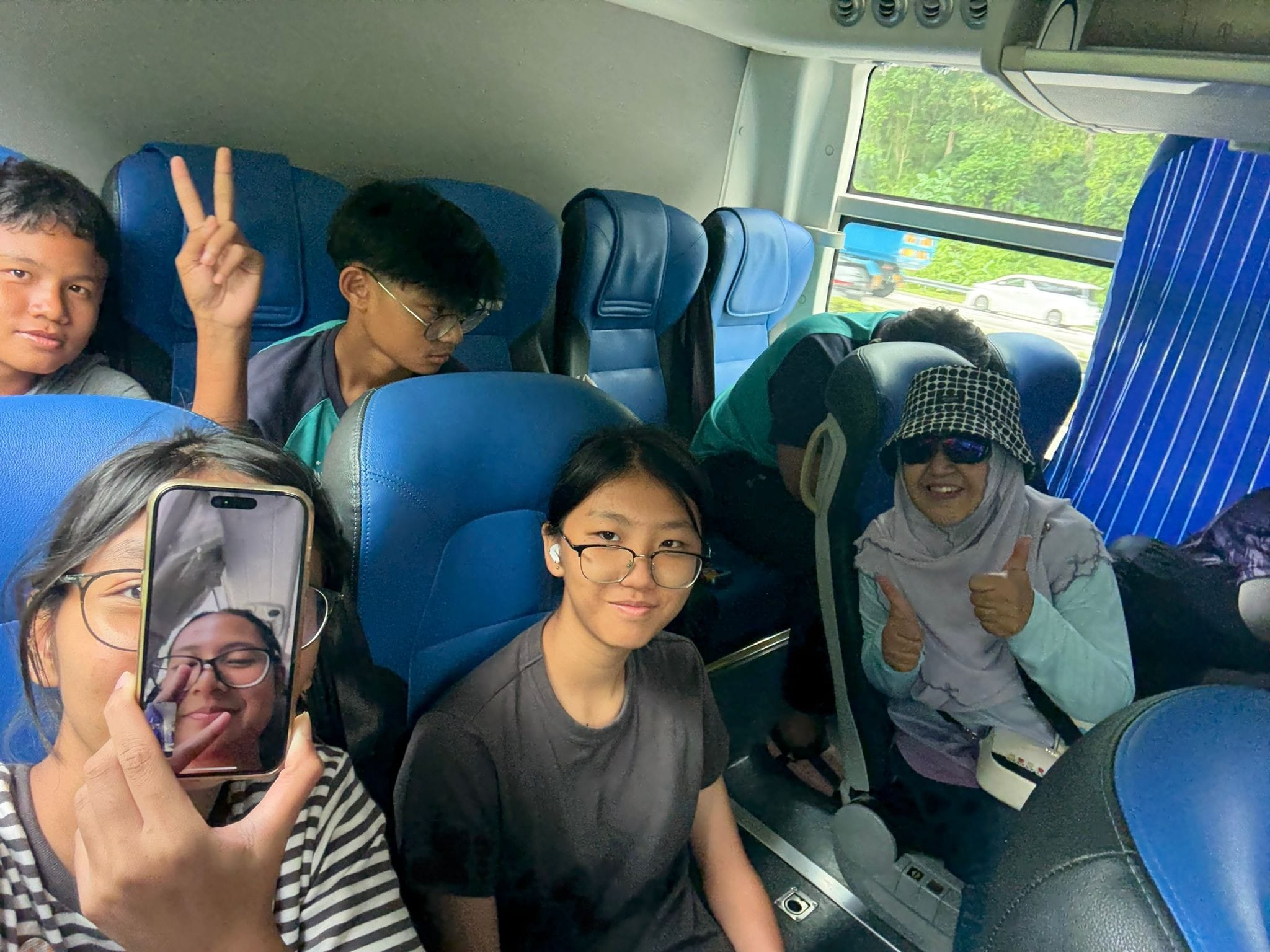 students posing for a photo on a bus