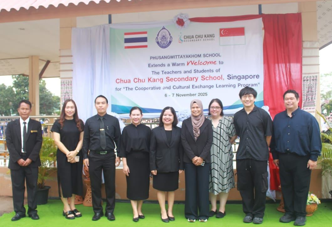 Eight people pose in front of a welcome banner for Chua Chu Kang Secondary School Singapore cultural exchange program.
