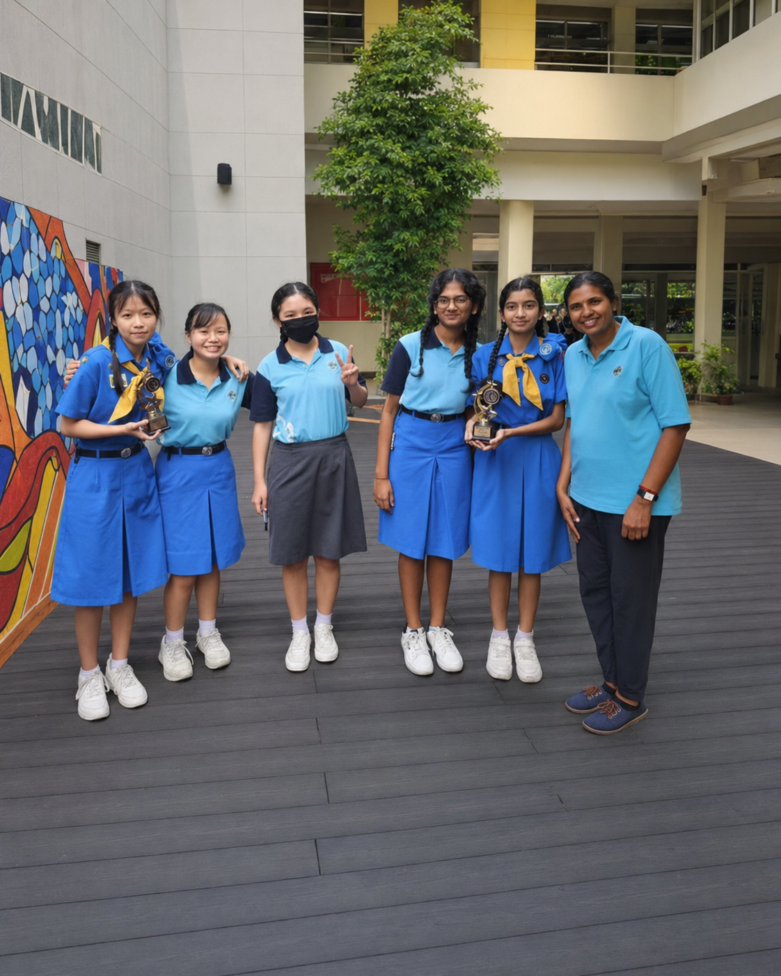 5 girl guides and 1 teacher posing for a photo