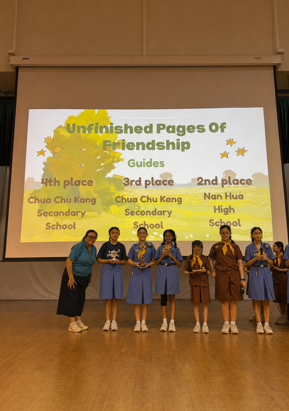 seven girl guides stand on stage