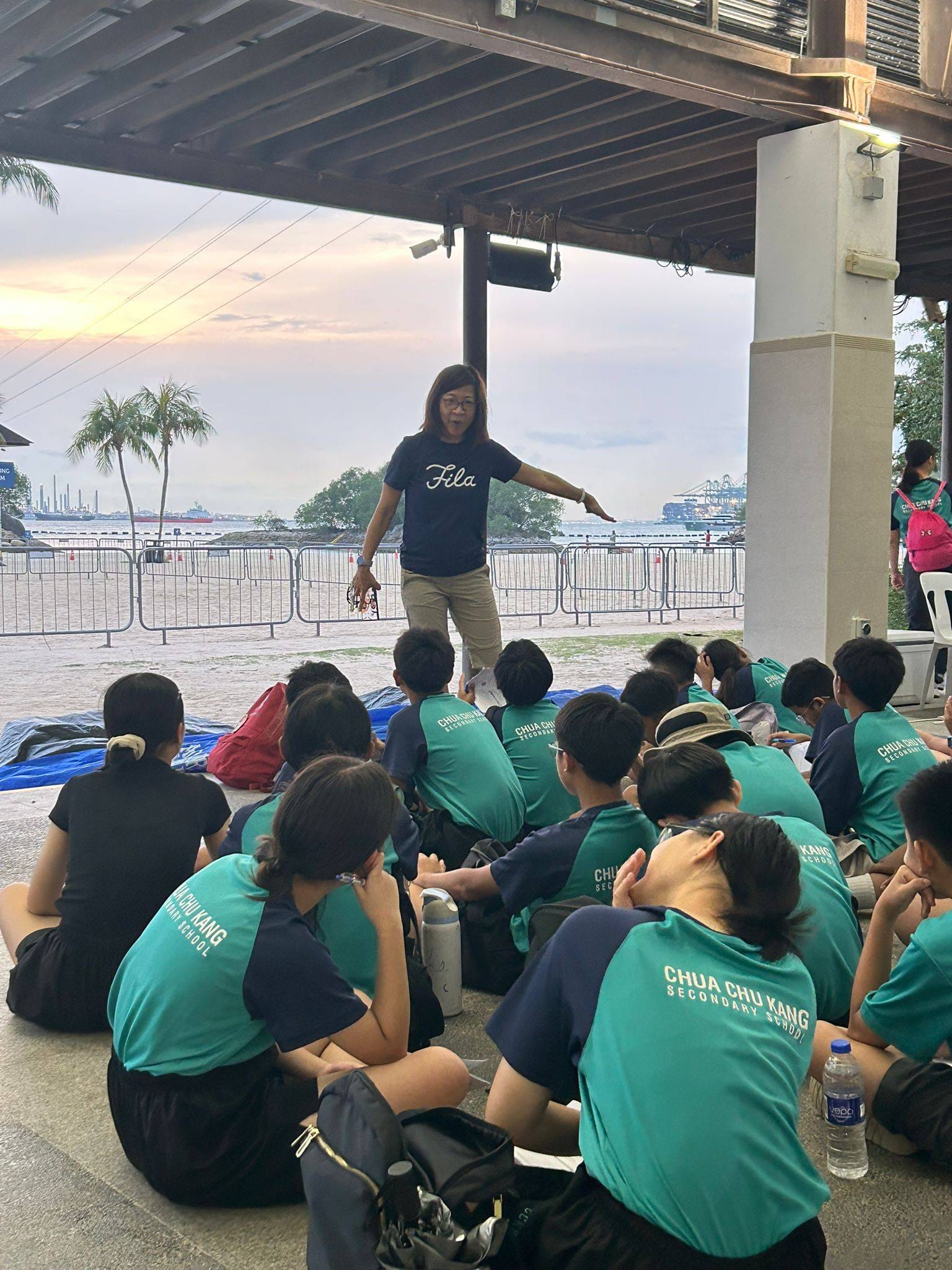 A teacher conducting a briefing for a group of students