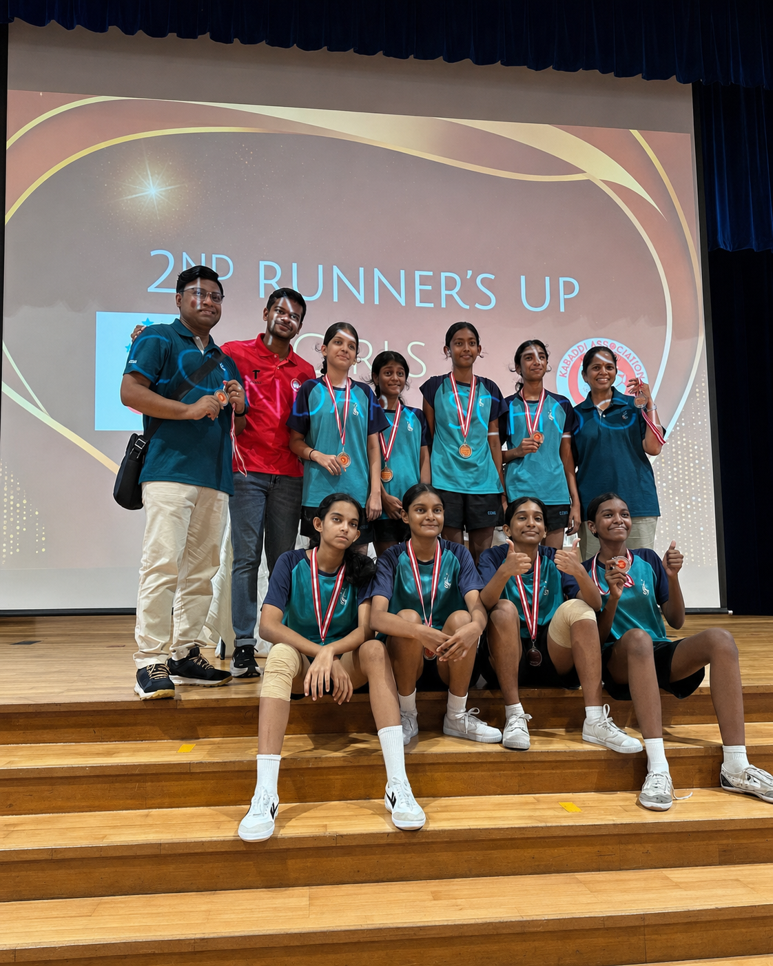 a group of students holding certificates in front of a screen