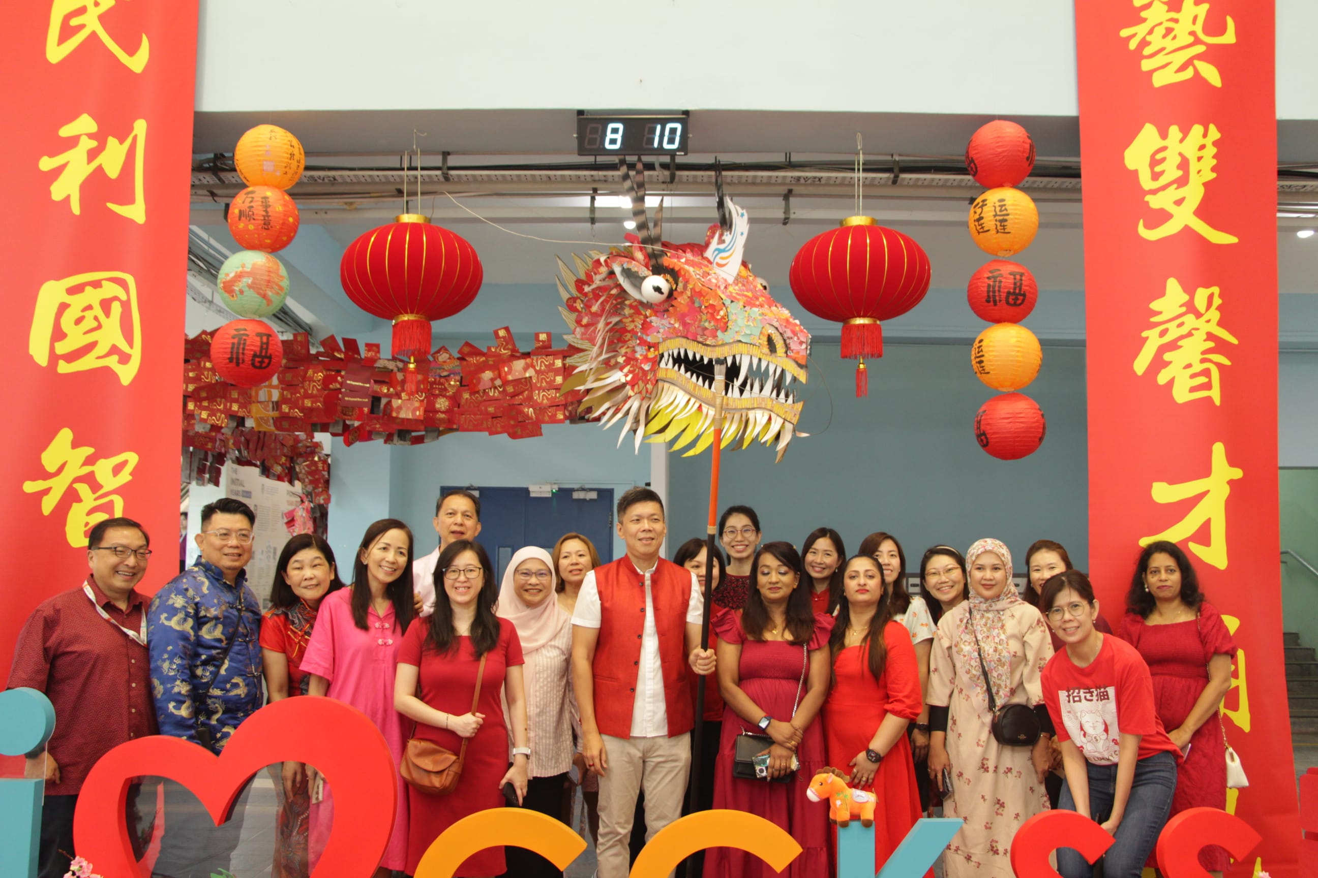 a group of people posing with cny decoration