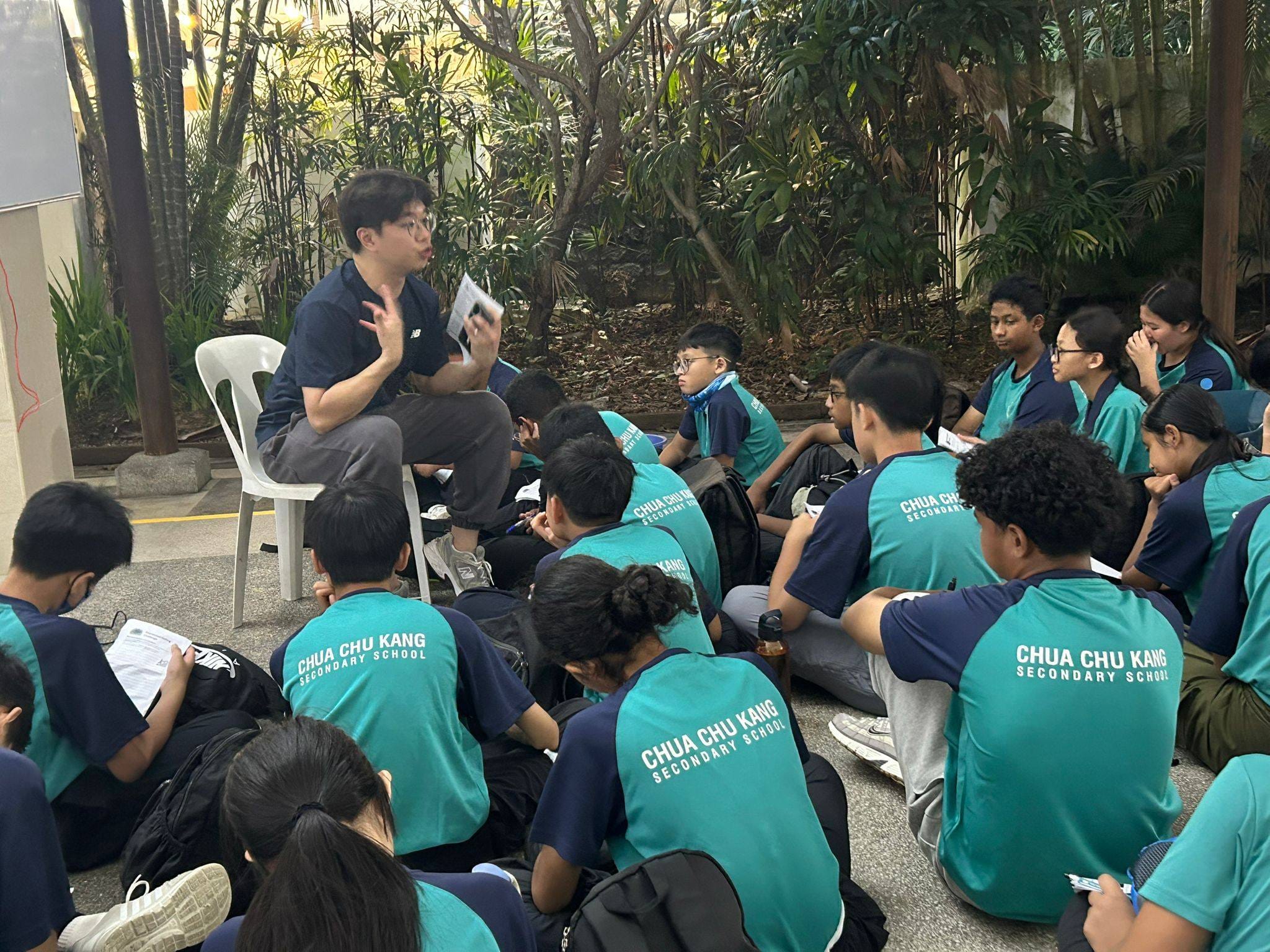 A teacher conducting a briefing for a group of students