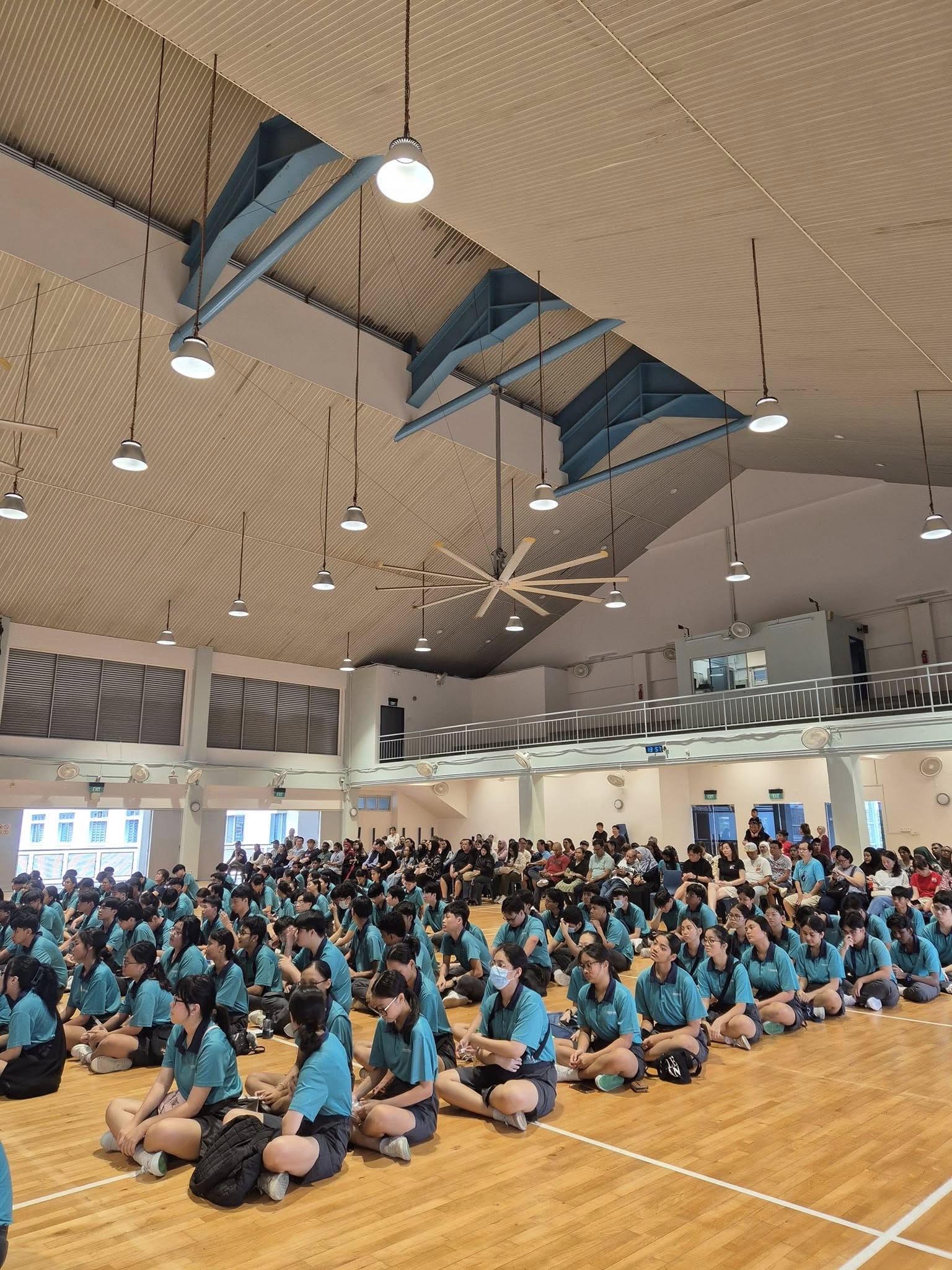 group of students sitting in a school hall