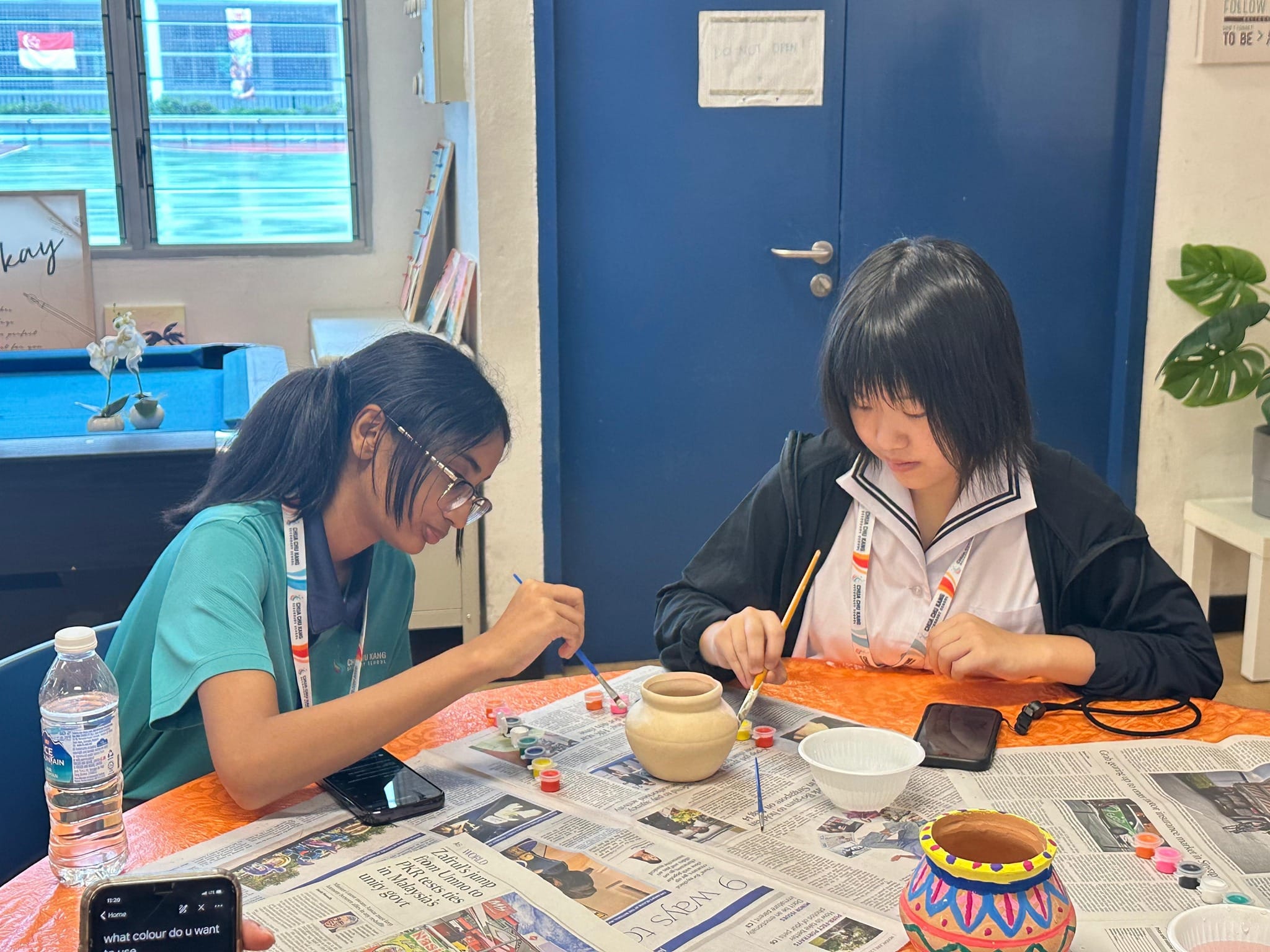Students painting a pongal pot