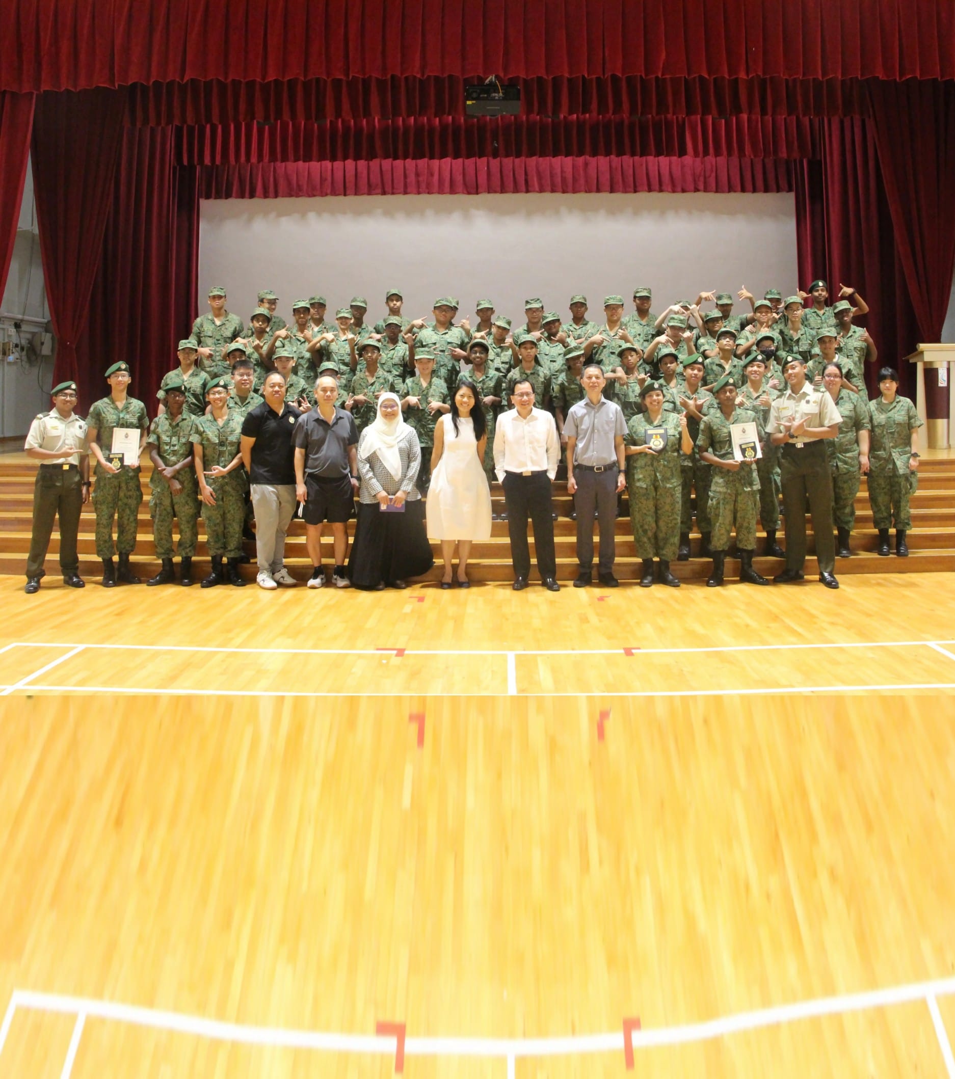 a group of ncc cadets and teacher officers pose near a stage