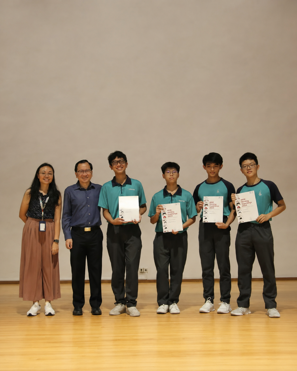 teacher, principal and four boys pose for a photo
