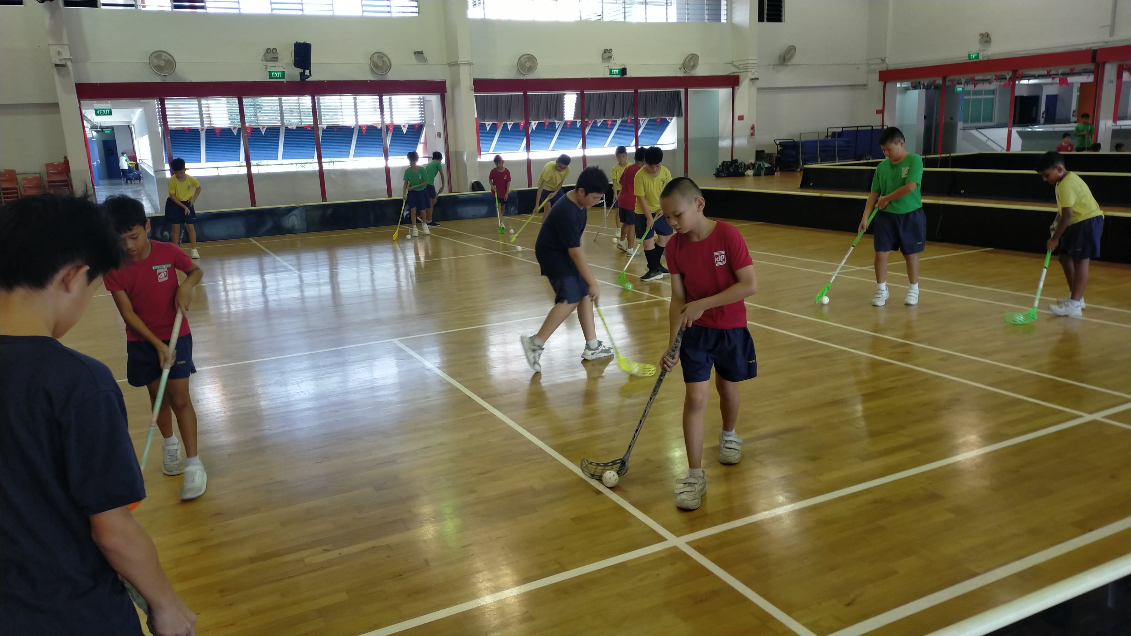 The Floorball boys practising with the floorball stick how to control the ball.
