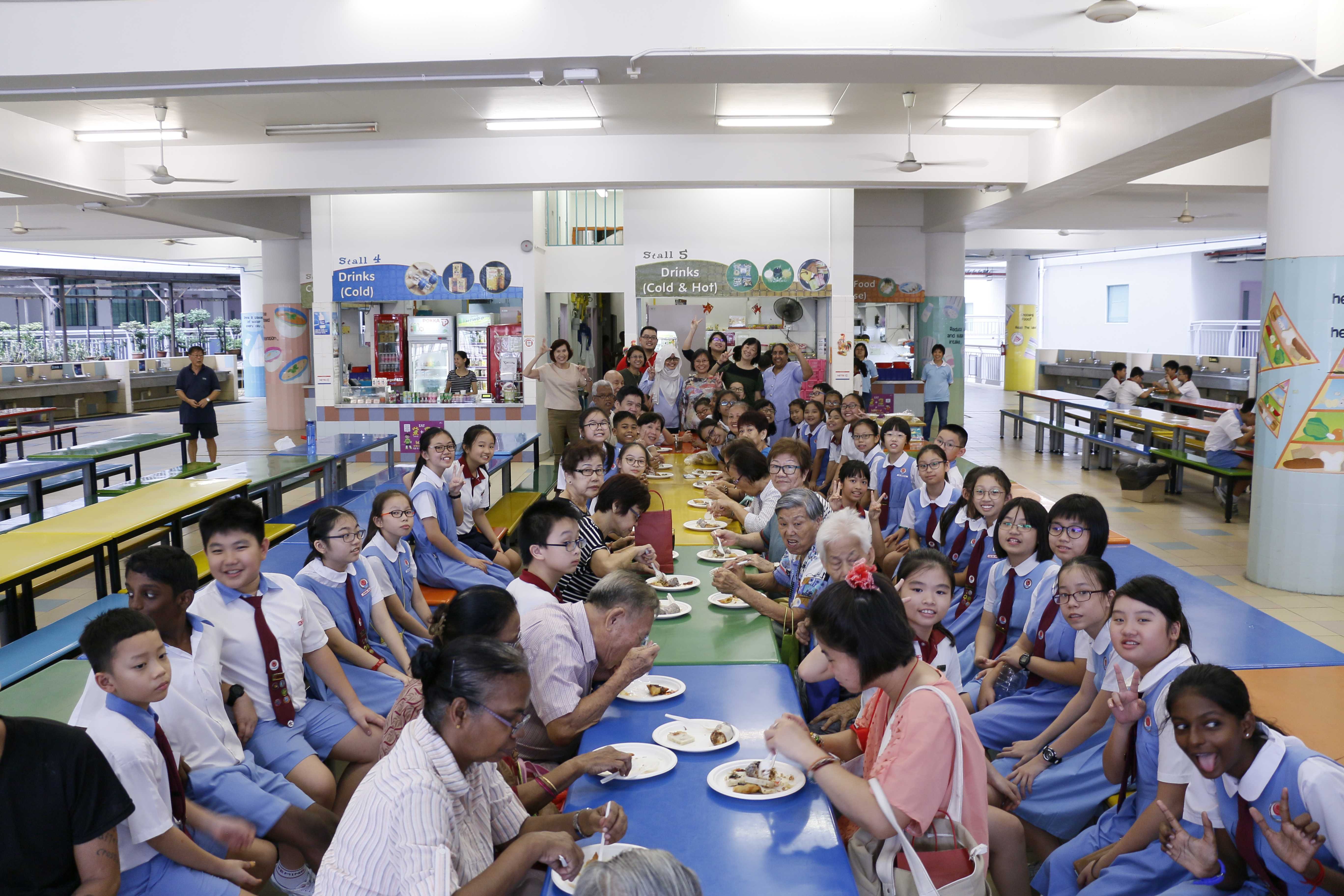 students and grandparents taking group photo