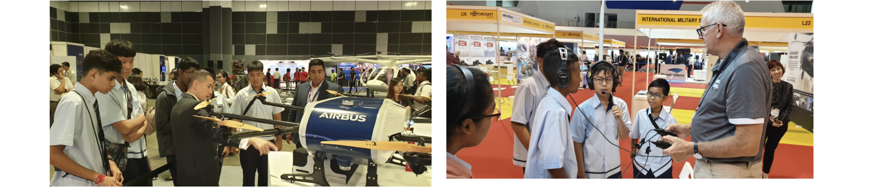 Students at an airshow examine an Airbus drone on the left and talk with an adult presenter wearing headphones on the right.