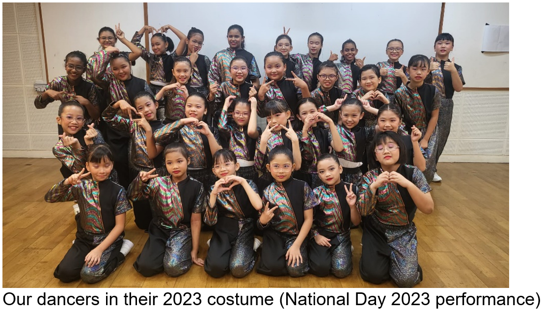 Group of young dancers in colorful black and holographic costumes posing with heart and peace hand signs.