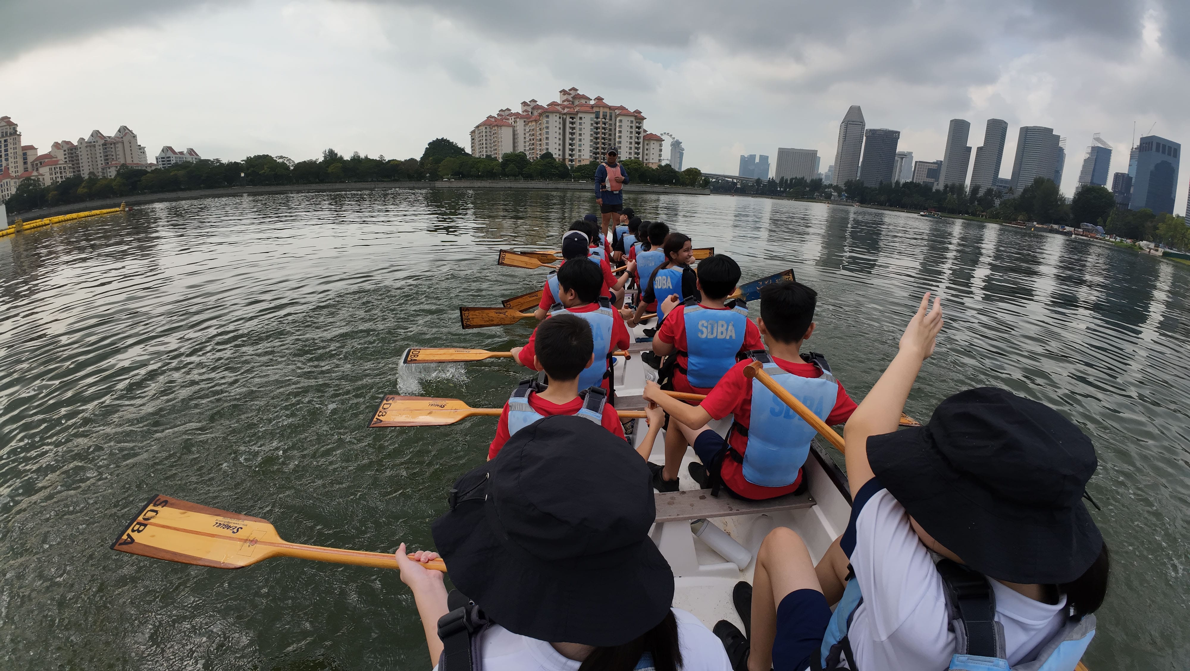 P6 students rowing a dragon boat.