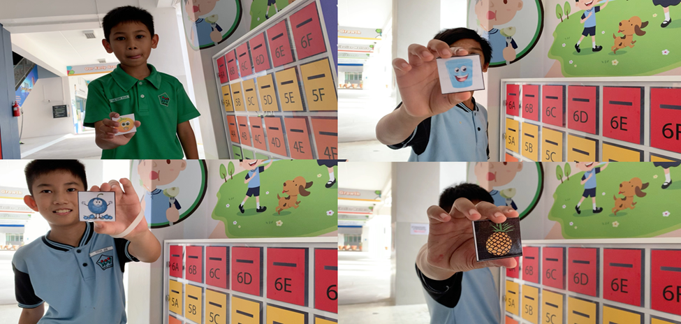 Four children each hold up a small illustrated card in front of colorful numbered school lockers.