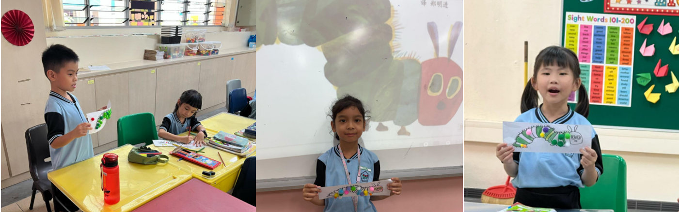 Three young students in a classroom hold colorful caterpillar drawings, with a projected caterpillar on the whiteboard behind them.