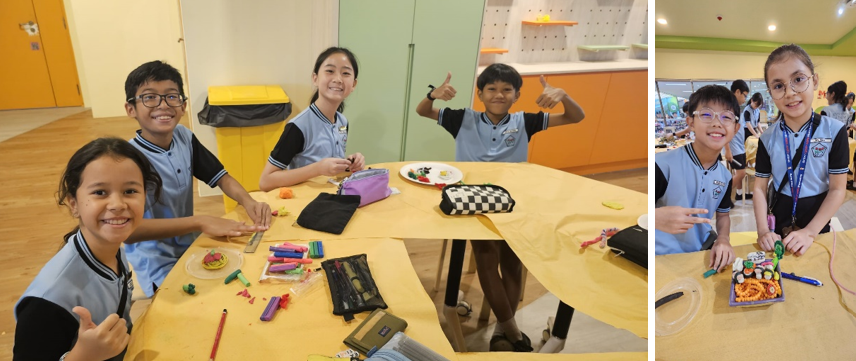 Four children in blue uniforms smile and give thumbs up at a table with colorful clay craft supplies.