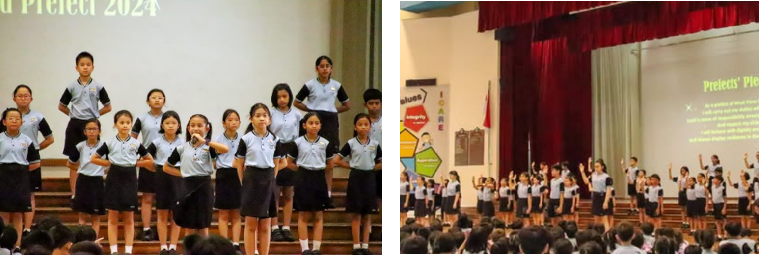 School students in uniforms stand on a stage during a Prefects 2024 ceremony, raising their hands in pledge.