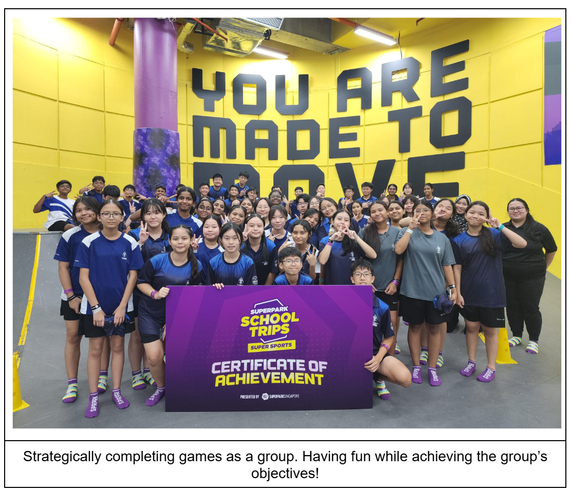 Large group of students posing in front of a yellow wall holding a SuperPark School Trips Certificate of Achievement sign.