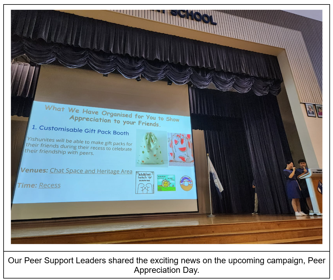 Two students present on stage beside a projected slide about a Customisable Gift Pack Booth for Peer Appreciation Day.