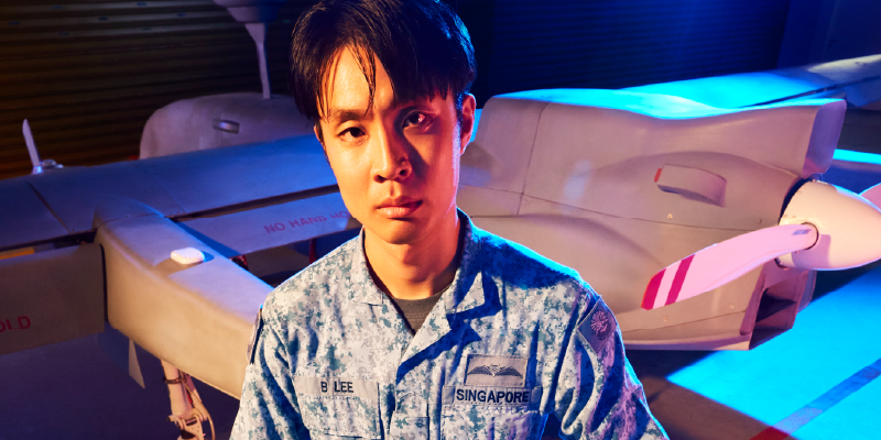 A RSAF UAV Pilot standing in front of a UAV.