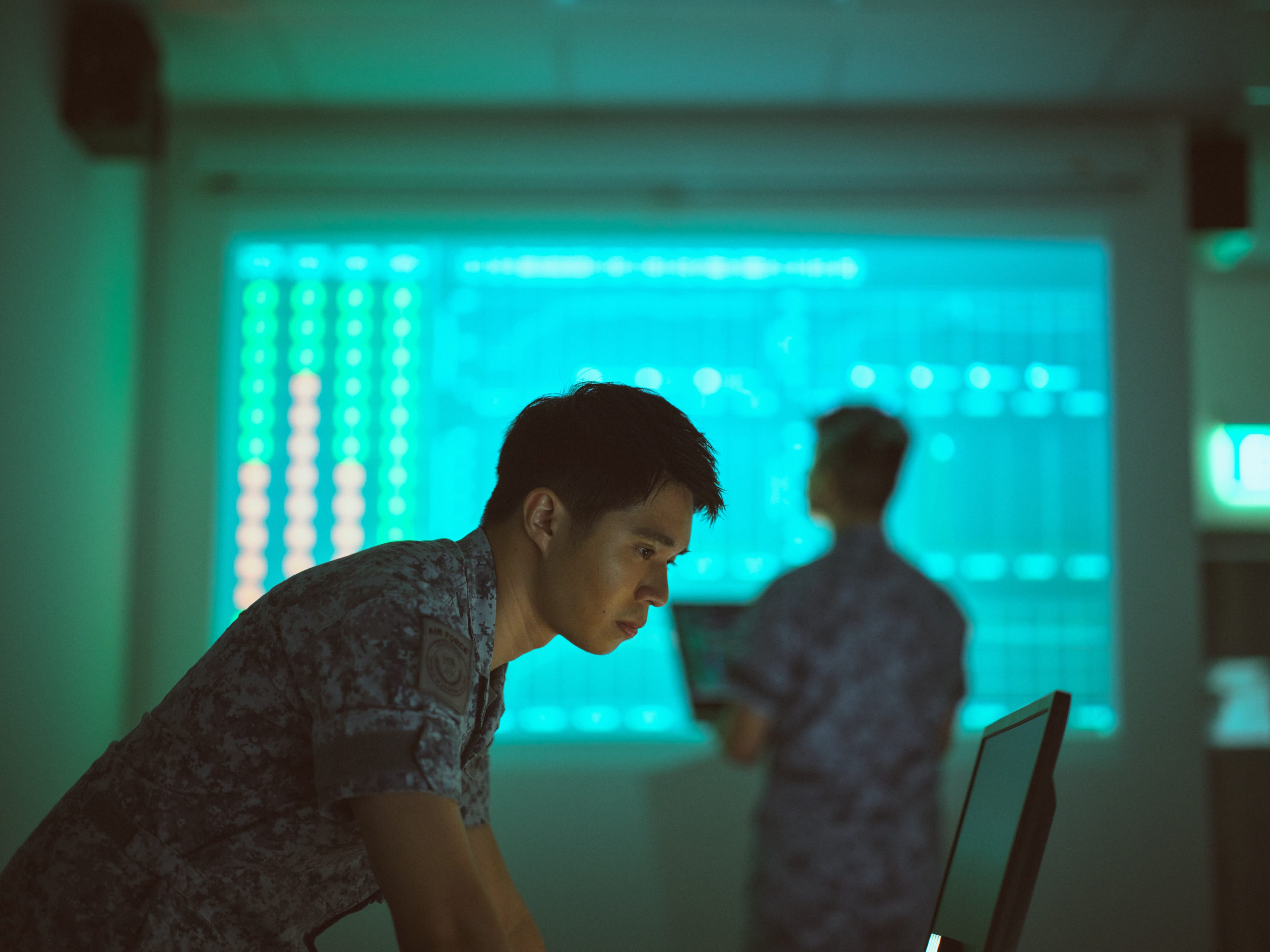 AFE in RSAF No.4 uniform at a high-tech workstation,