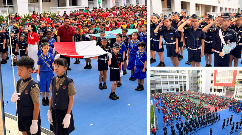 School assembly with children in uniforms carrying a red and white flag, saluting, and standing in formation outdoors.