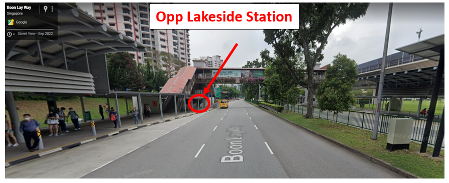 Street view of Boon Lay Way in Singapore showing a bus stop opposite Lakeside MRT Station with a yellow taxi on the road.