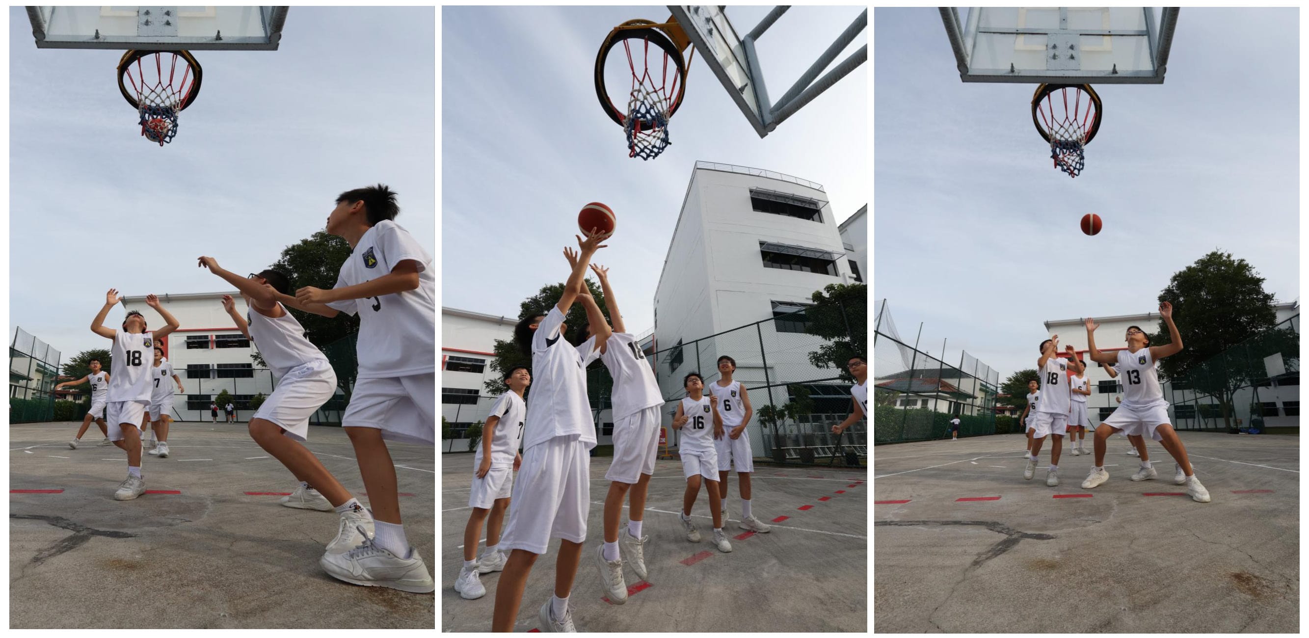 A group of boys in uniform hold a basketball, photographed from below.