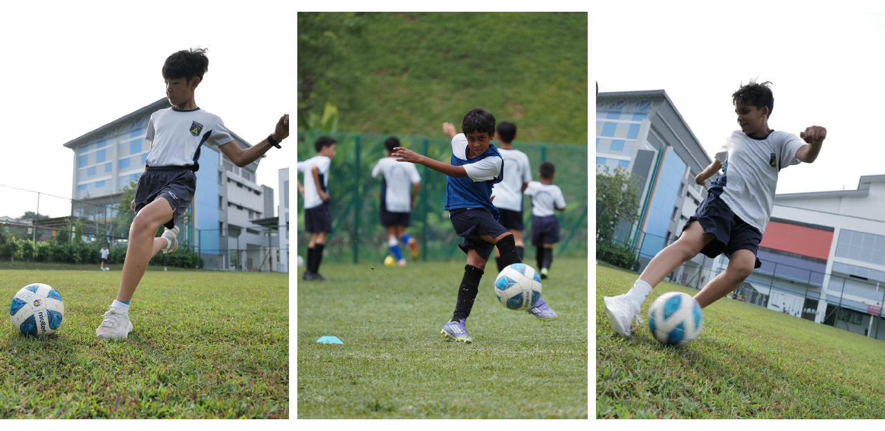 Three boys in school uniforms kicking soccer balls on a grass field in Bukit Timah Primary School.