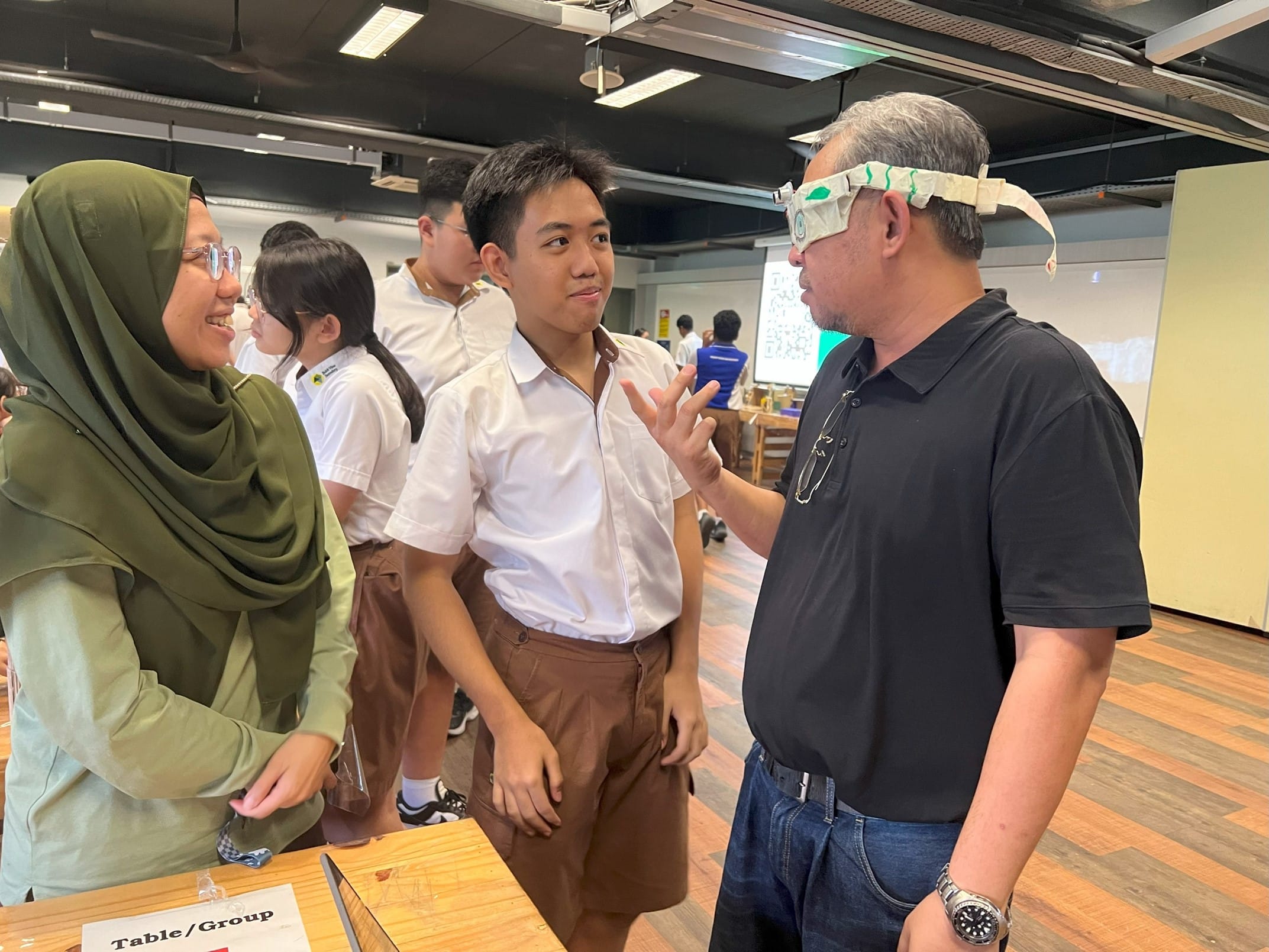 Student demonstrating smart glasses designed to support the visually impaired during a JOULES learning activity.