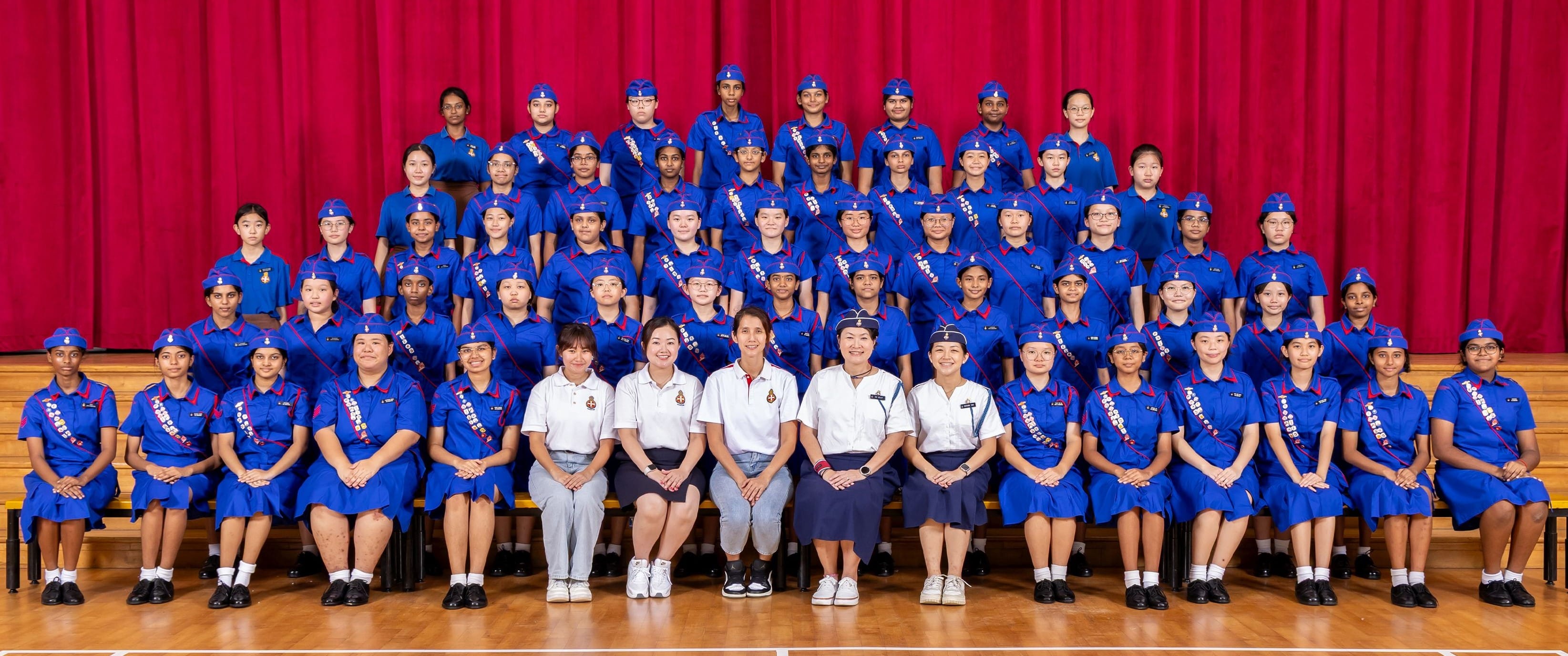 Girls' Brigade members and Teachers-in-Charge posing together for a group photograph.