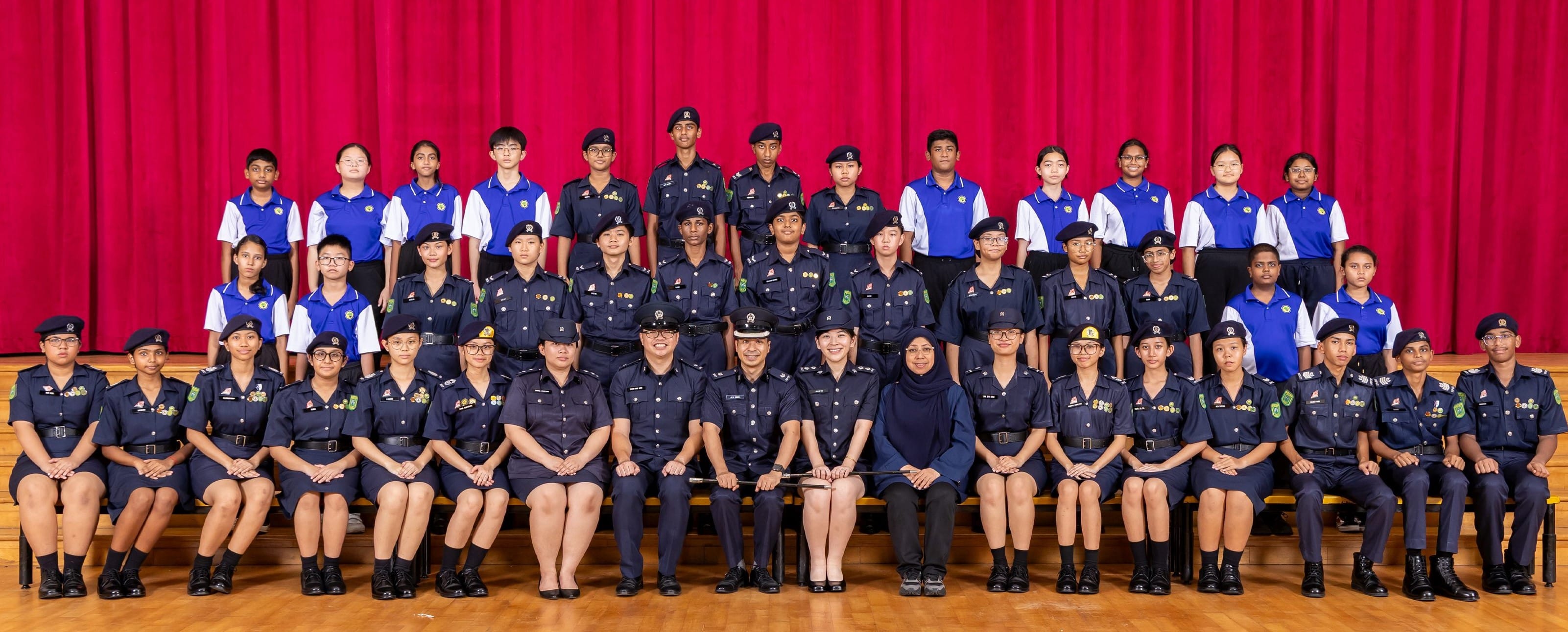 National Police Cadets and Teachers-in-Charge posing together for a group photograph.