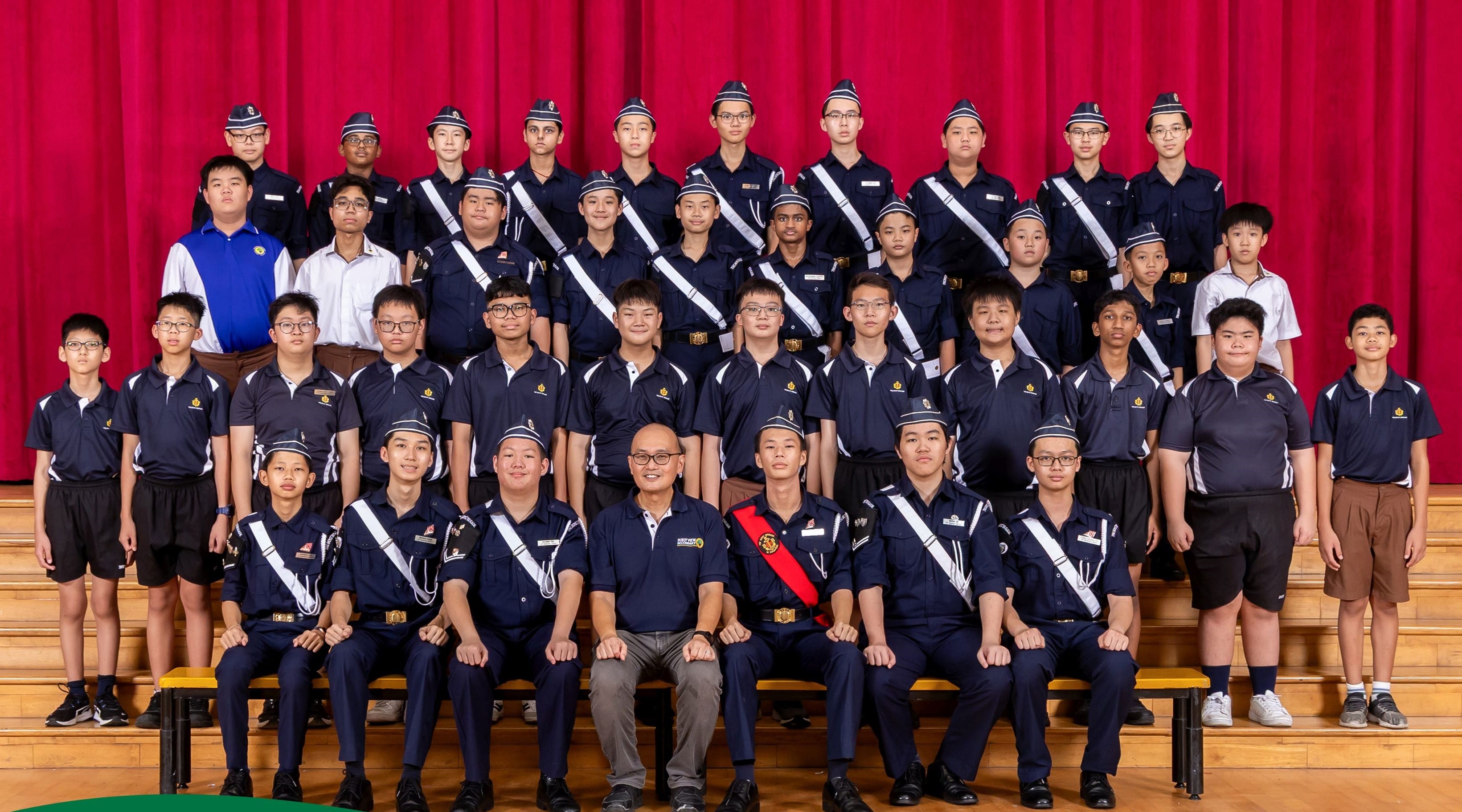Boys' Brigade members and Teachers-in-Charge posing together for a group photograph.
