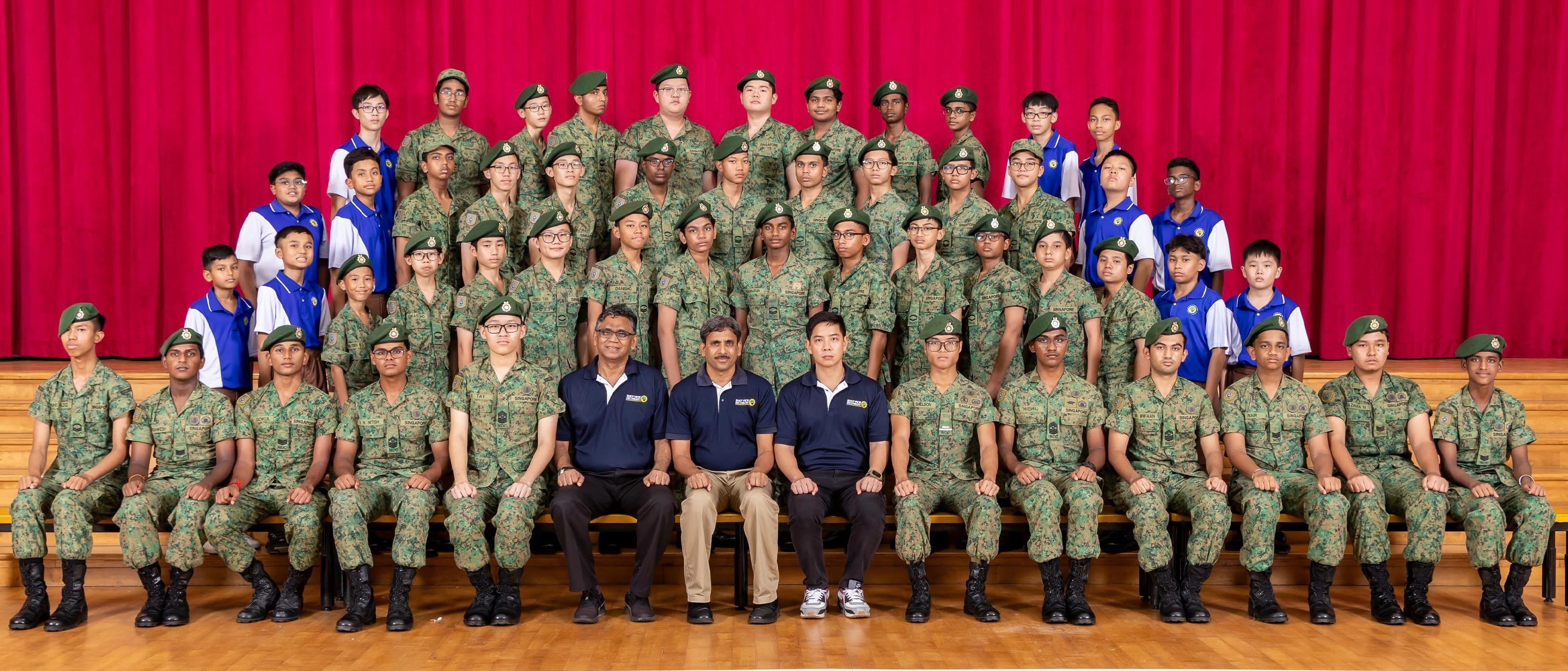 NCC members and Teachers-in-Charge posing together for a group photograph.