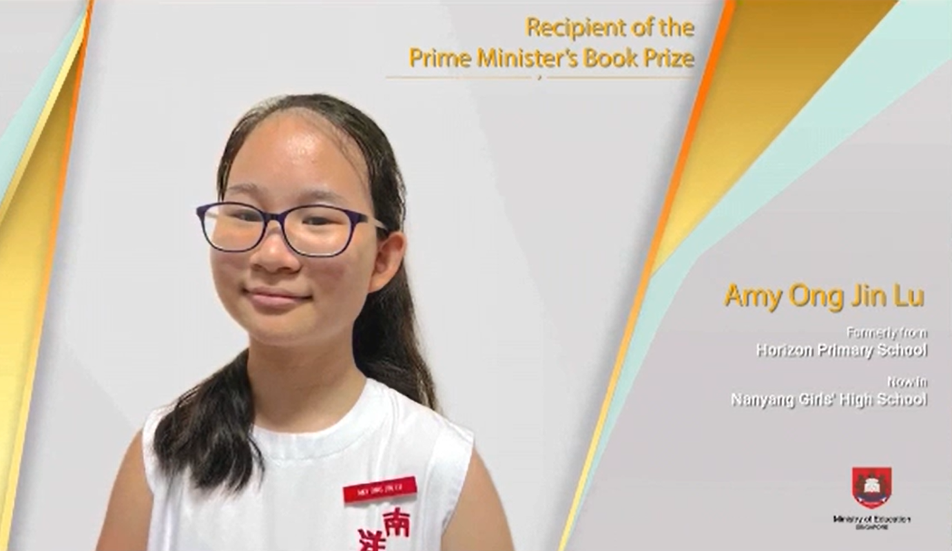 Young girl with glasses named Amy Ong Jin Lu, recipient of the Prime Minister's Book Prize, smiling in a white top.