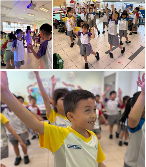 Young children in school uniforms dancing with arms raised in a classroom activity.