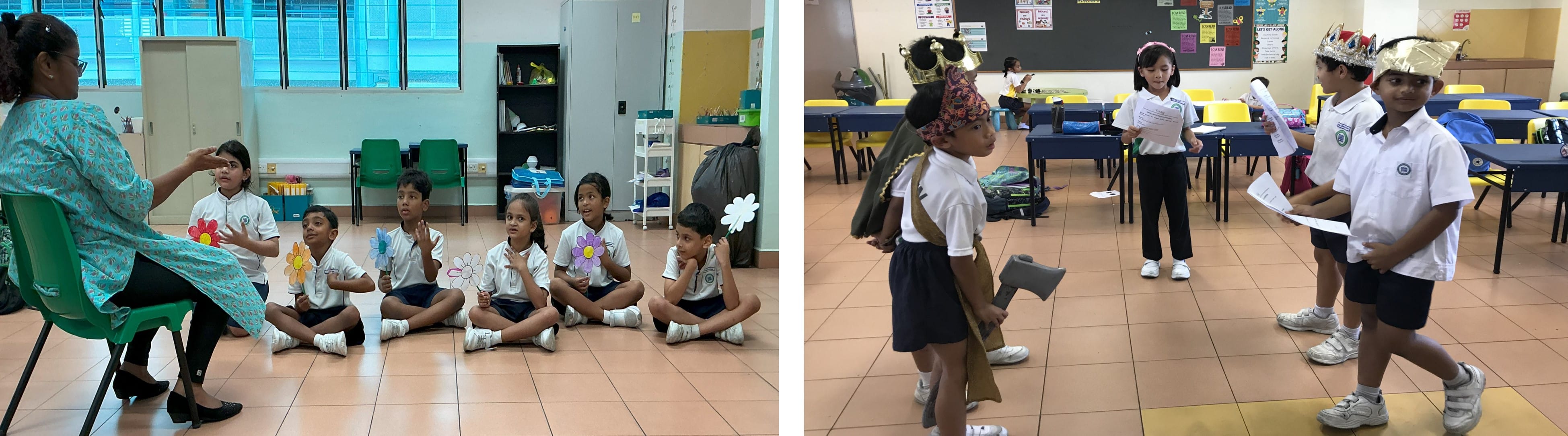 Young students in uniforms sit on a floor holding paper flowers with a teacher, while others wear costumes in a classroom.