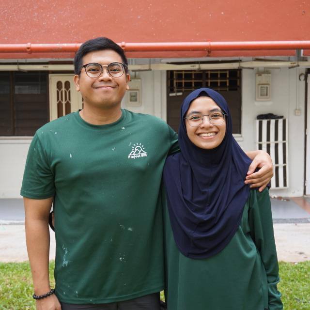 Zulayqha and her brother, cofounder of Project Hills, standing together outdoors